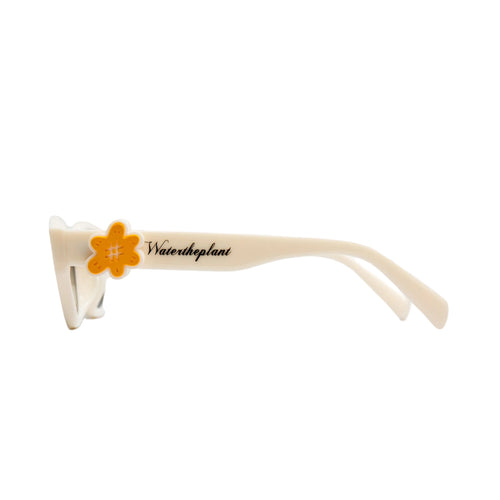 Off-white sunglasses with a bright orange flower accent on the temple arm, featuring the text 'Watertheplant' printed in black script.