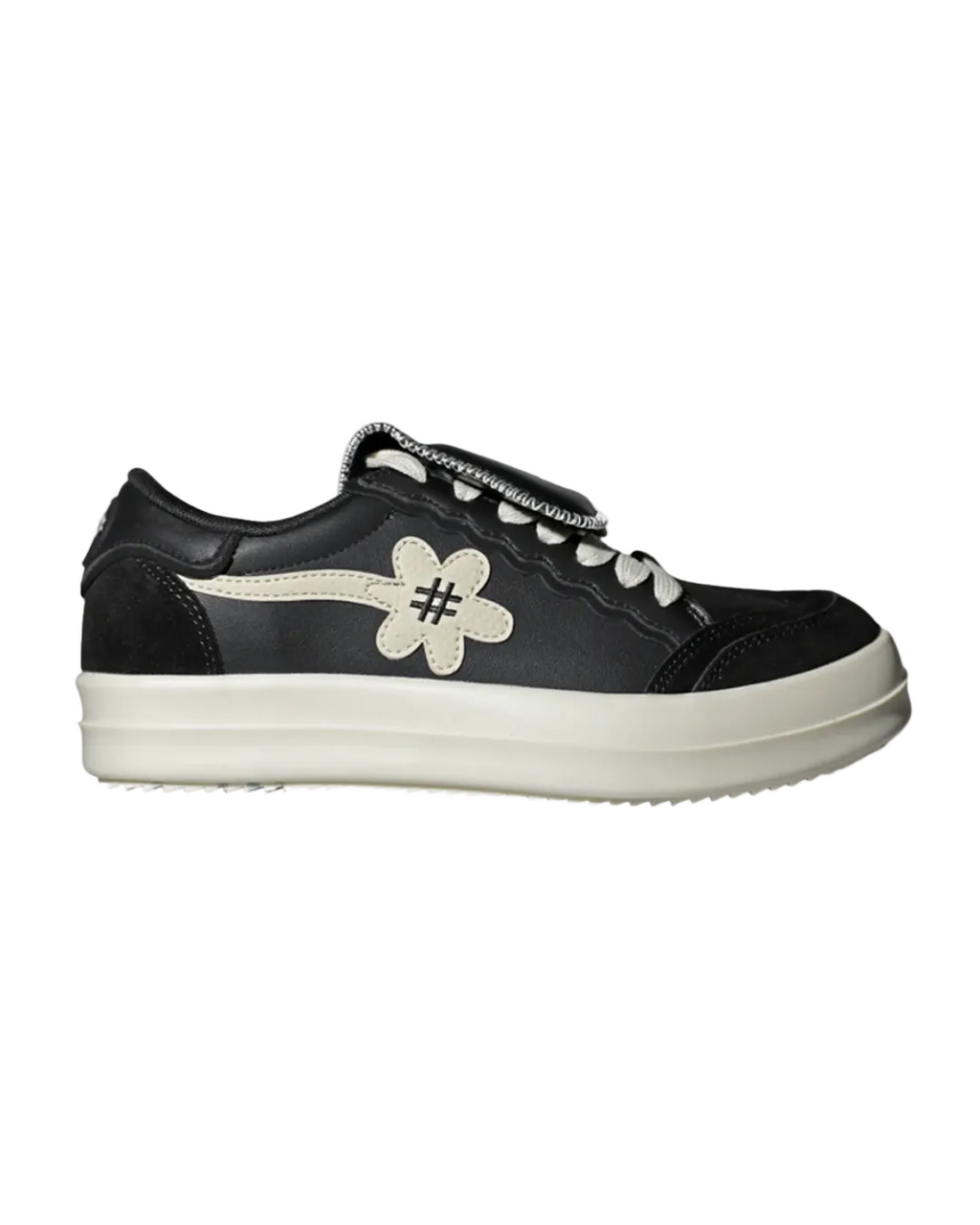 Black sneaker with a white flower design on a white background