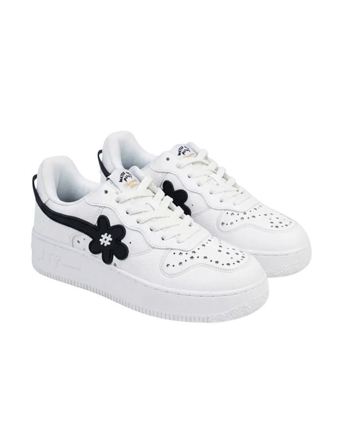 White sneakers with black floral design on a white background