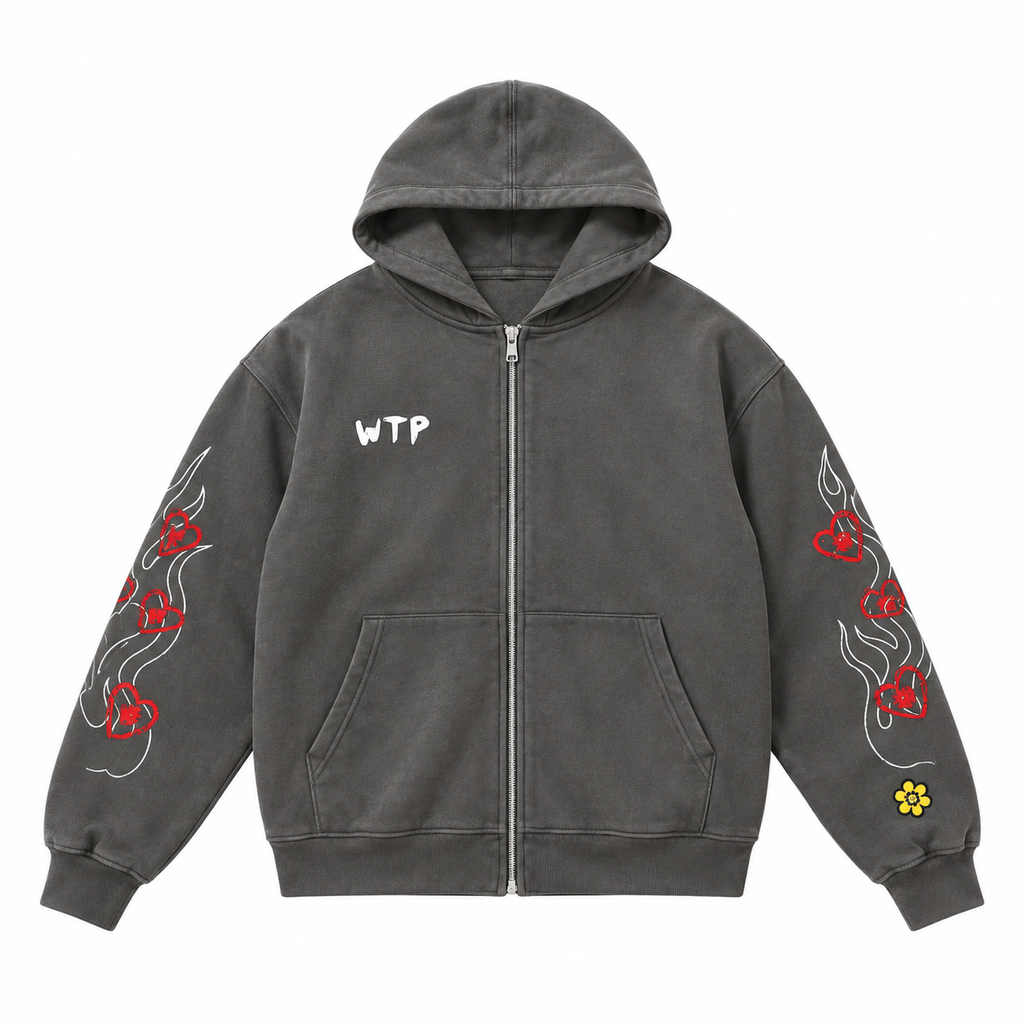 A dark gray zip-up hoodie with a white 'WTP' text graphic on the chest, white flame designs on one sleeve, red flame and heart designs on the other sleeve, and a small yellow flower patch near the cuff.