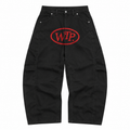 Black cargo-style denim pants featuring a red oval 'WTP' logo on the front thigh, photographed flat against a solid white background.