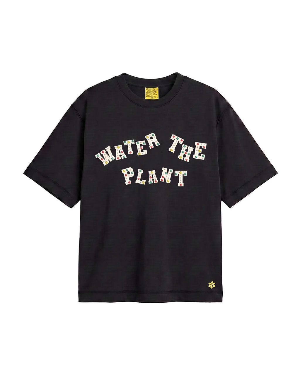 A black short-sleeve t-shirt with 'WATER THE PLANT' charms across the chest, featuring a small yellow flower logo on the bottom right hem and a yellow brand label inside the collar.