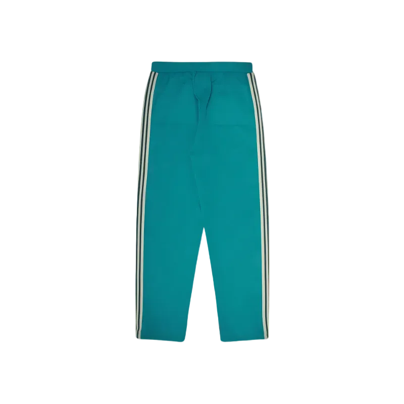 A pair of teal track pants with white and black side stripes, displayed flat against a solid white background.