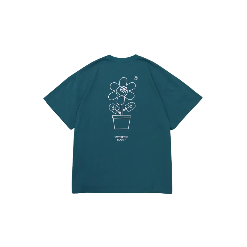 Teal t-shirt with a white flower graphic and text on the back against a white background
