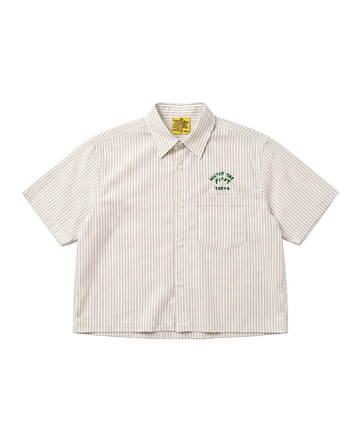 A short-sleeve button-up shirt with thin vertical beige and brown stripes, featuring a green embroidered chest logo that reads 'WATER THE PLANT TOKYO' with a tree graphic. The shirt is laid flat against a clean white background.