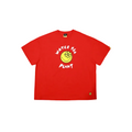 A bright red short-sleeve t-shirt with a graphic on the chest featuring a yellow smiley face with a flower and the words 'WATER THE PLANT' in white. A small yellow flower logo is printed on the bottom right hem.