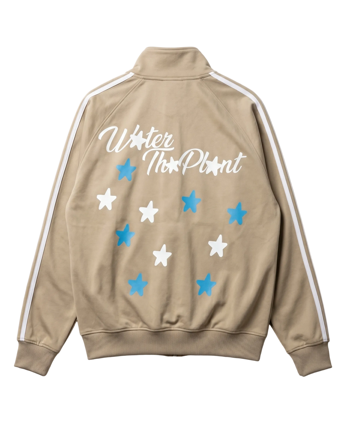 A beige track jacket shown from the back, featuring white and blue star graphics with the text 'WATER THE PLANT' Plant' in white script. The jacket has white stripes down the sleeves and a mock neck collar, set against a plain white background.