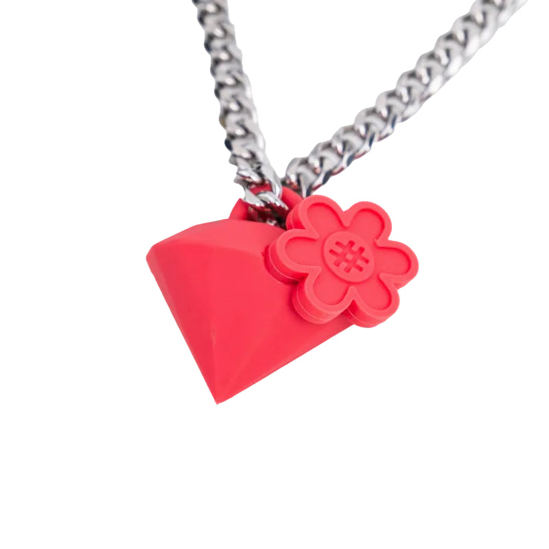 A red diamond-shaped pendant necklace with a red flower charm on a silver chain, shown against a plain white background.