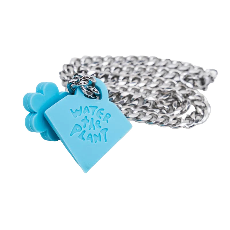 A silver chain necklace featuring a light blue silicone heart-shaped pendant engraved with 'WATER THE PLANT' and a matching blue flower clasp, shown on a white background.