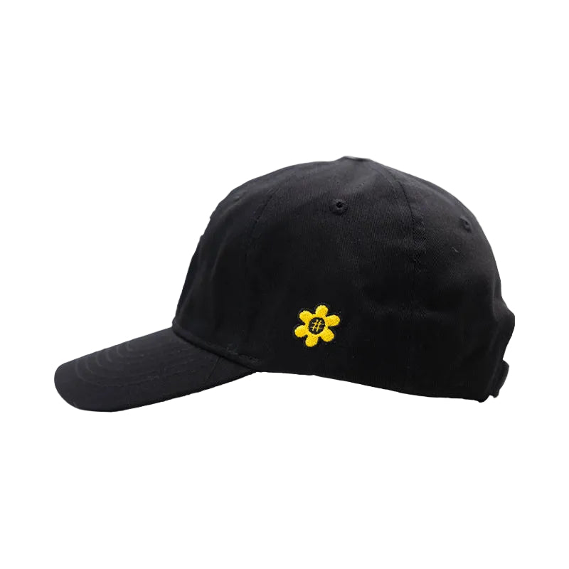 A black baseball cap featuring a small yellow embroidered flower logo in the side center, set against a plain white background.