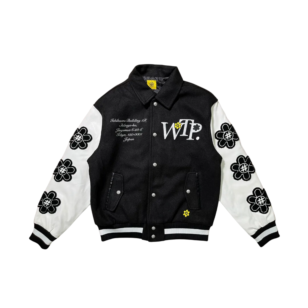 Black and white varsity jacket with floral designs and text on a white background