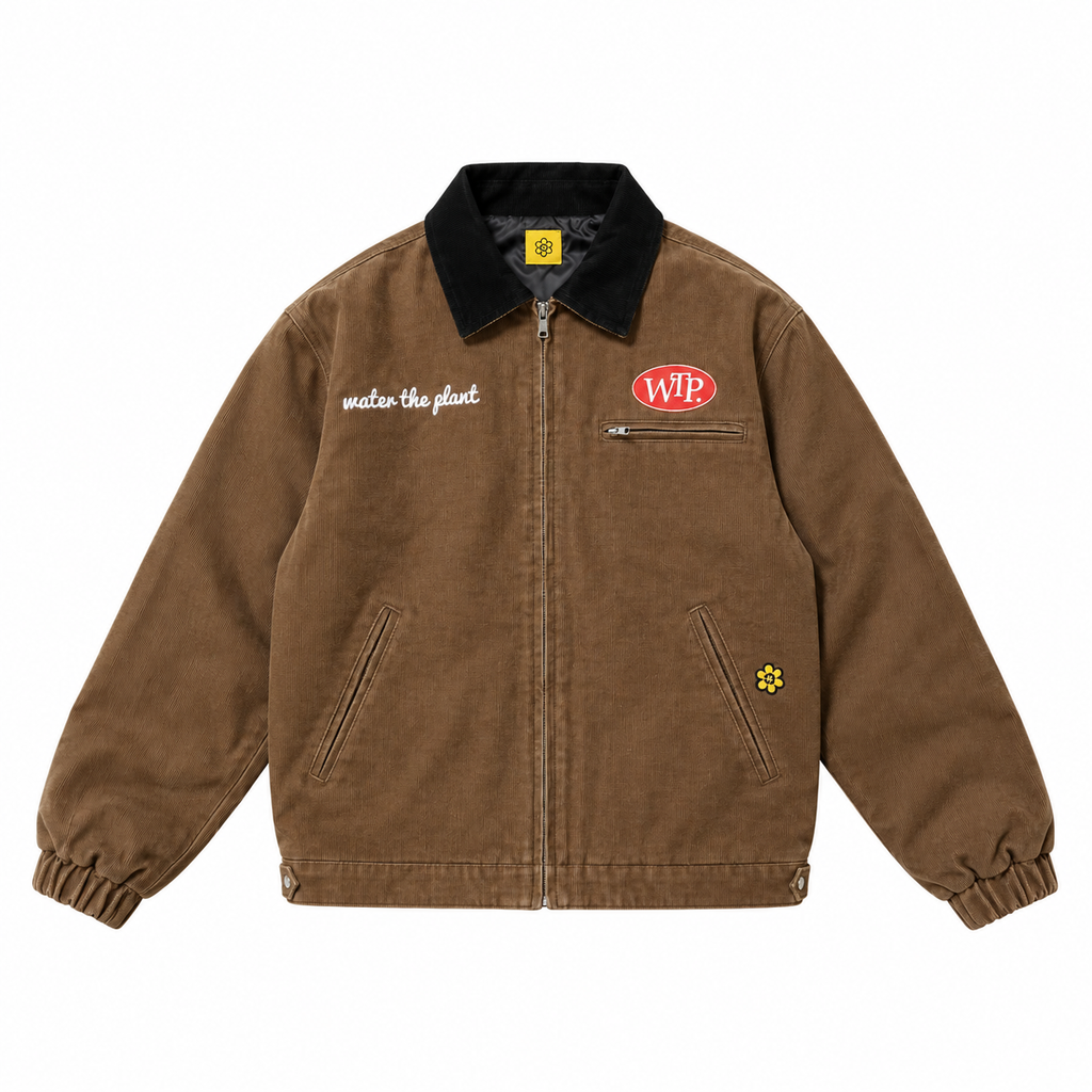 A brown canvas utility jacket with a black corduroy collar, featuring a red oval 'WTP' logo on the left chest, white WATER THE PLANT script text on the right chest, and a small yellow flower patch on the lower right pocket.