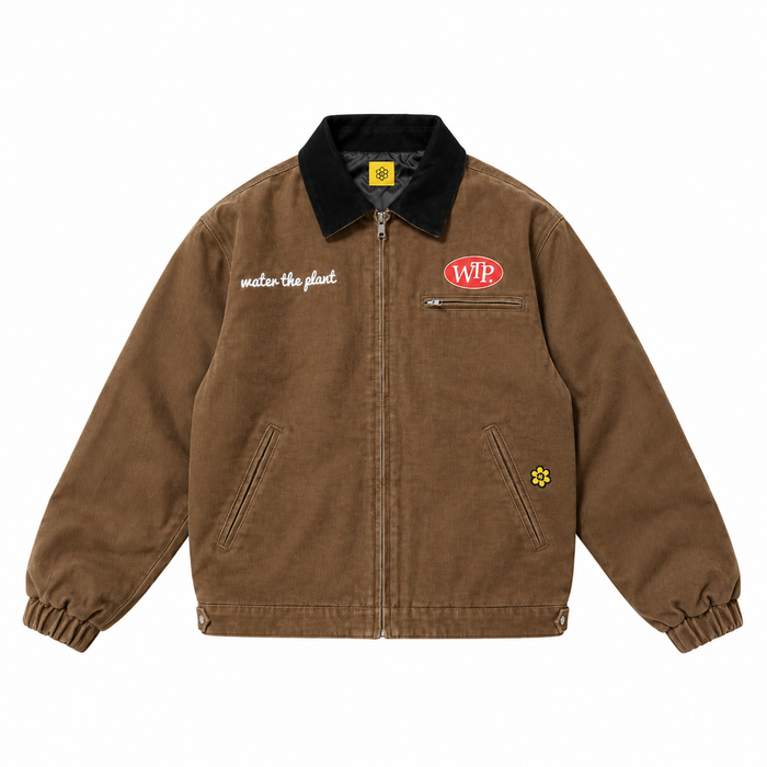 A brown canvas utility jacket with a black corduroy collar, featuring a red oval 'WTP' logo on the left chest, white WATER THE PLANT script text on the right chest, and a small yellow flower patch on the lower right pocket.